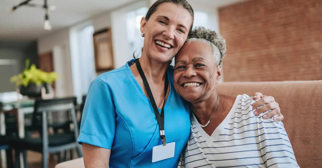nurse and patient smiling together at the camera