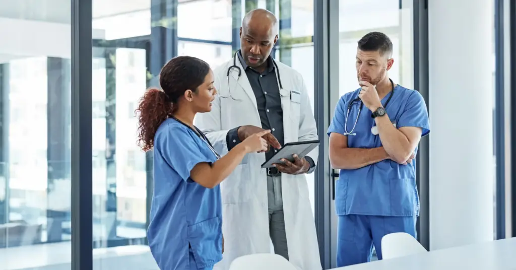 physicians discussing information on a digital tablet