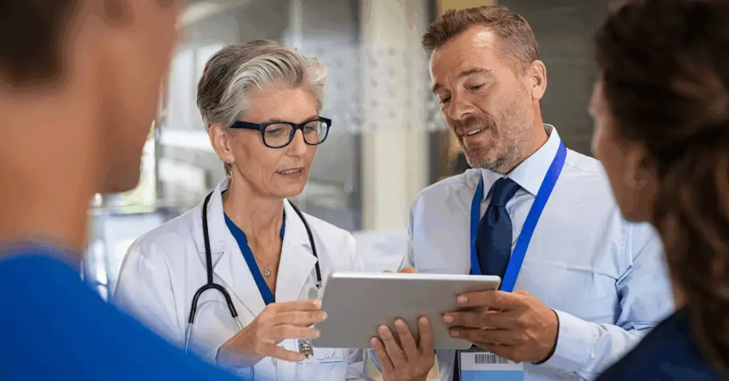 doctor talking to other medical professionals with digital tablet