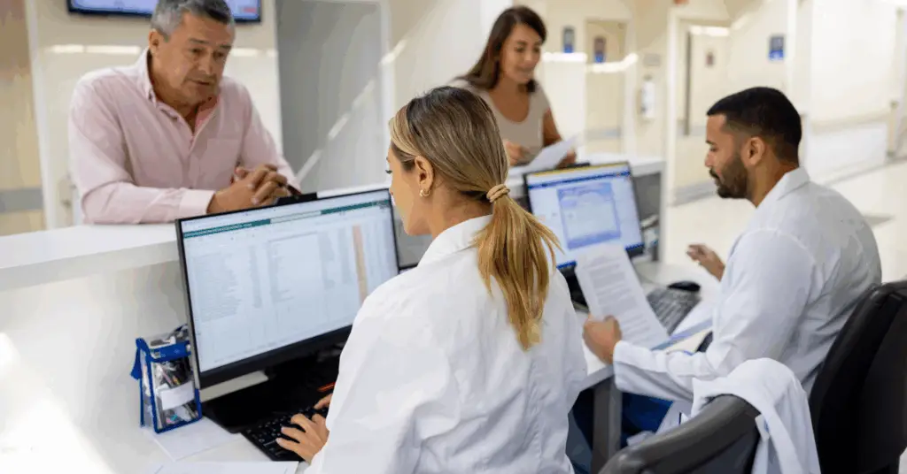 medical professionals talking to patients and working on computers