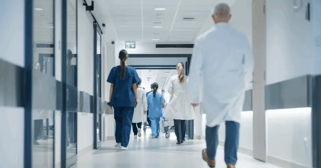 medical professionals walking down hospital hall