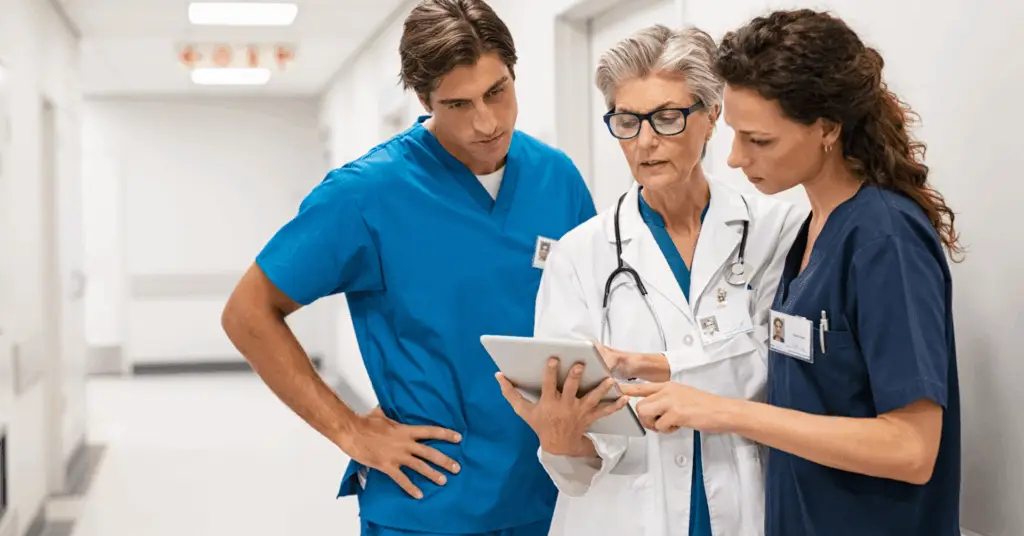 three medical professionals talking in the hospital
