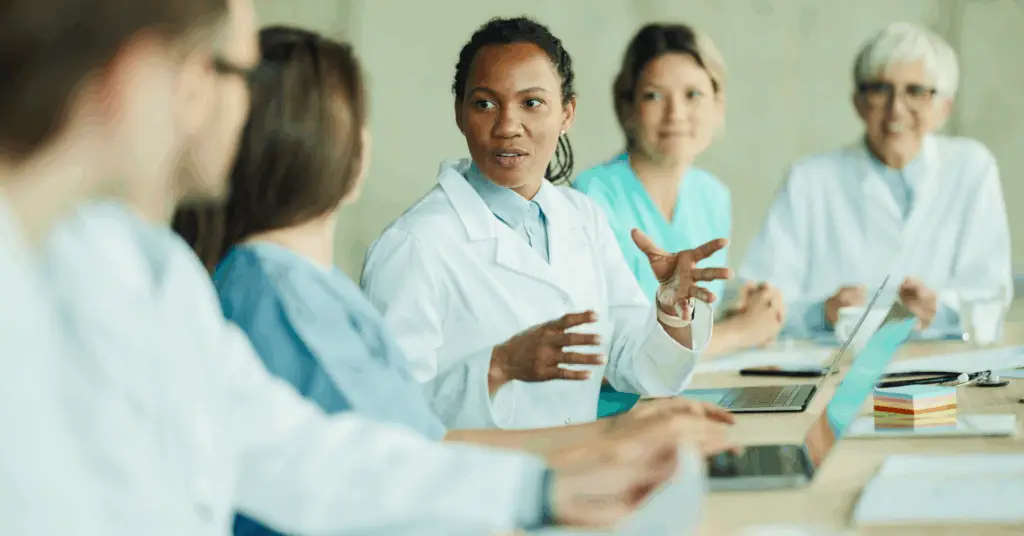 Group healthcare professionals discussing at a conference table
