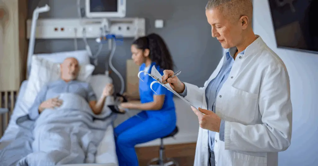 doctor making notes for patient in hospital bed