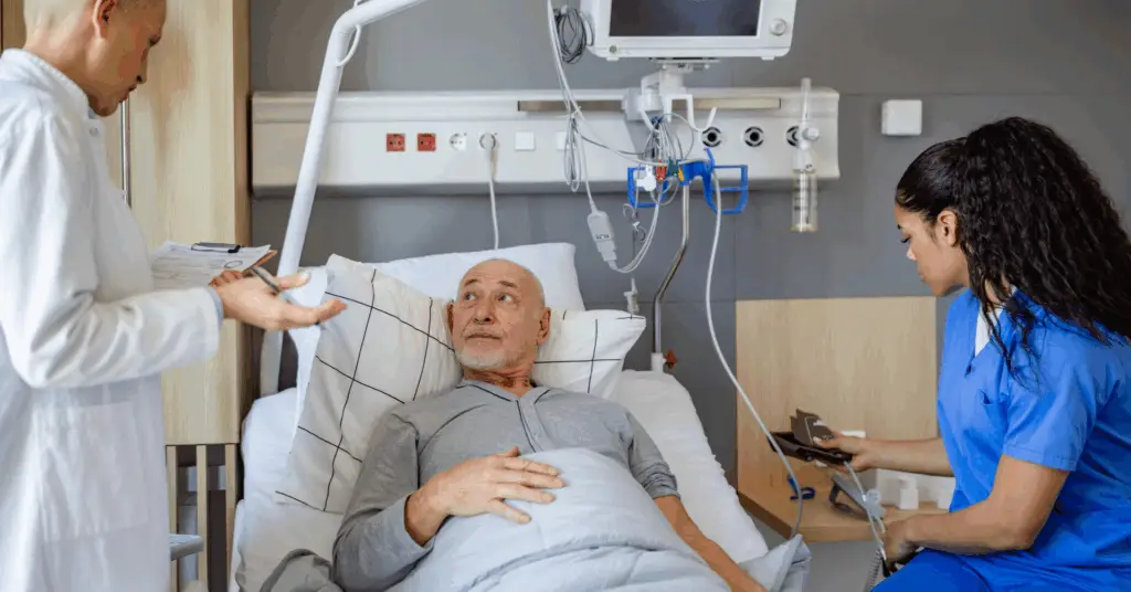 doctor making patient notes at patient bedside
