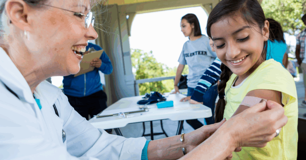 doctor putting band aid on child