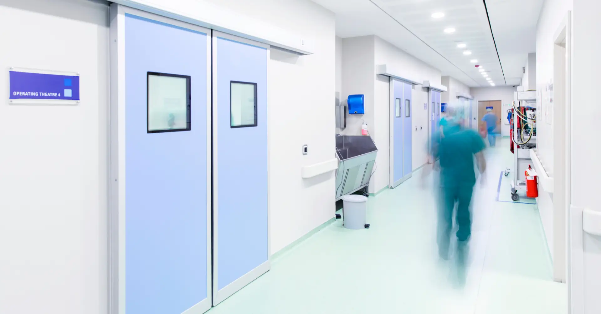doctor rushing around ER halls in hospital