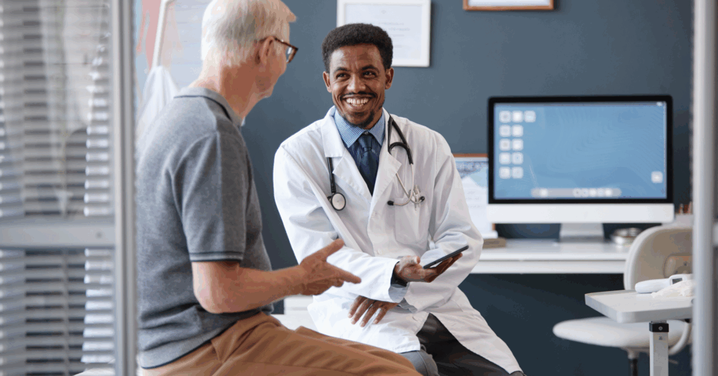 doctor speaking to a male patient in a hospital room
