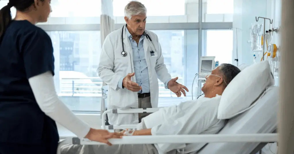 doctor talking to patient at hospital bedside