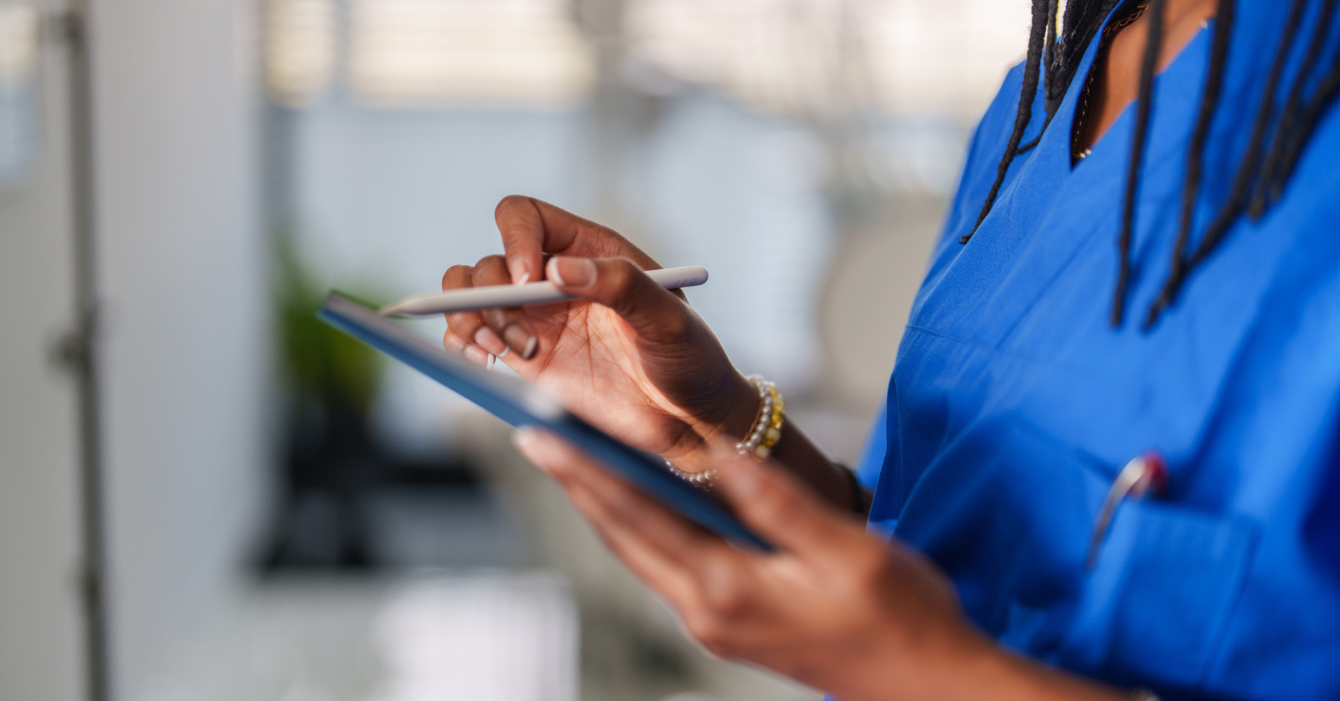 female medical professional working on a digital tablet