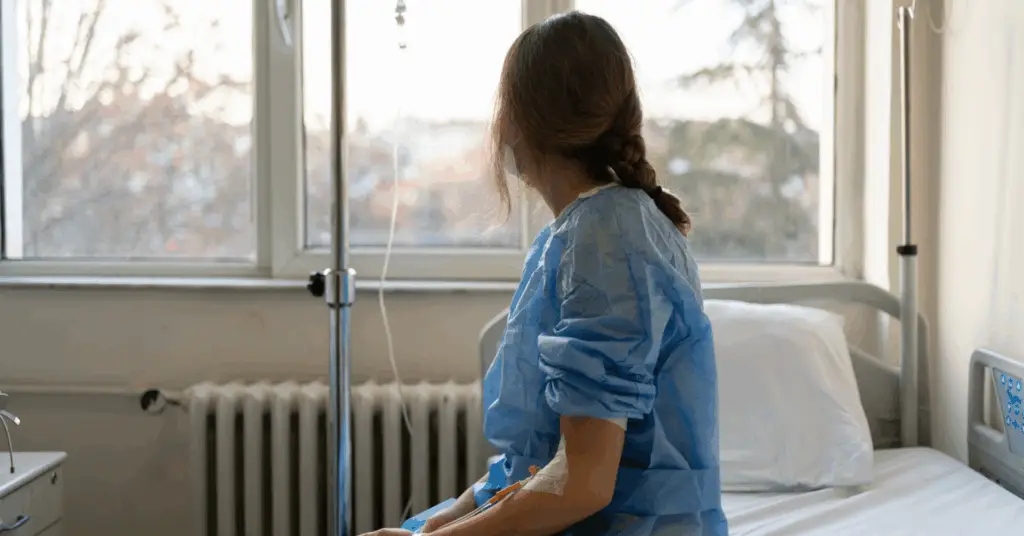 female patient looks out of a hospital window