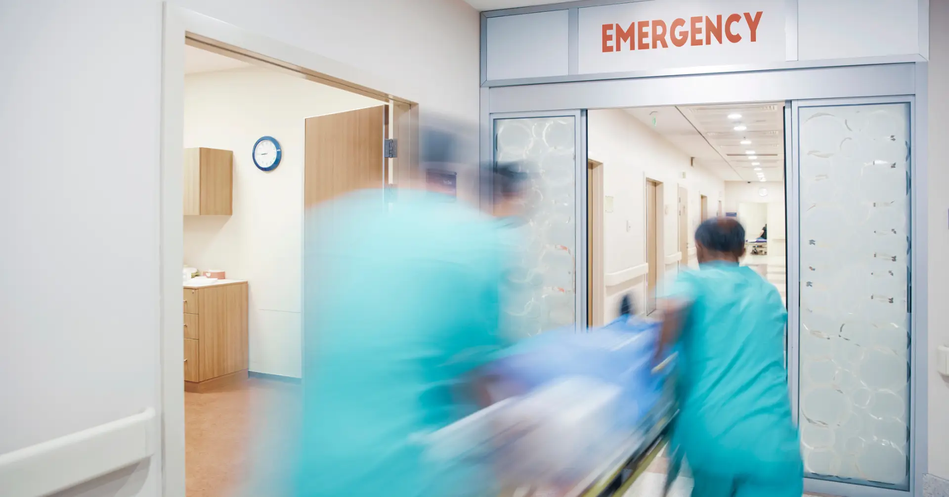 medics pushing patient in er
