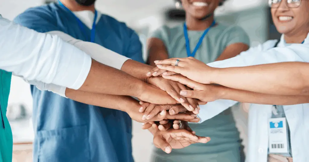physician hands in and smiling