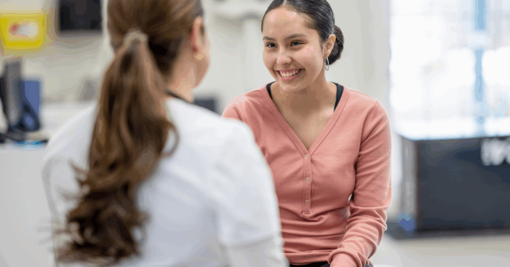 physician smiling at patient in hospital