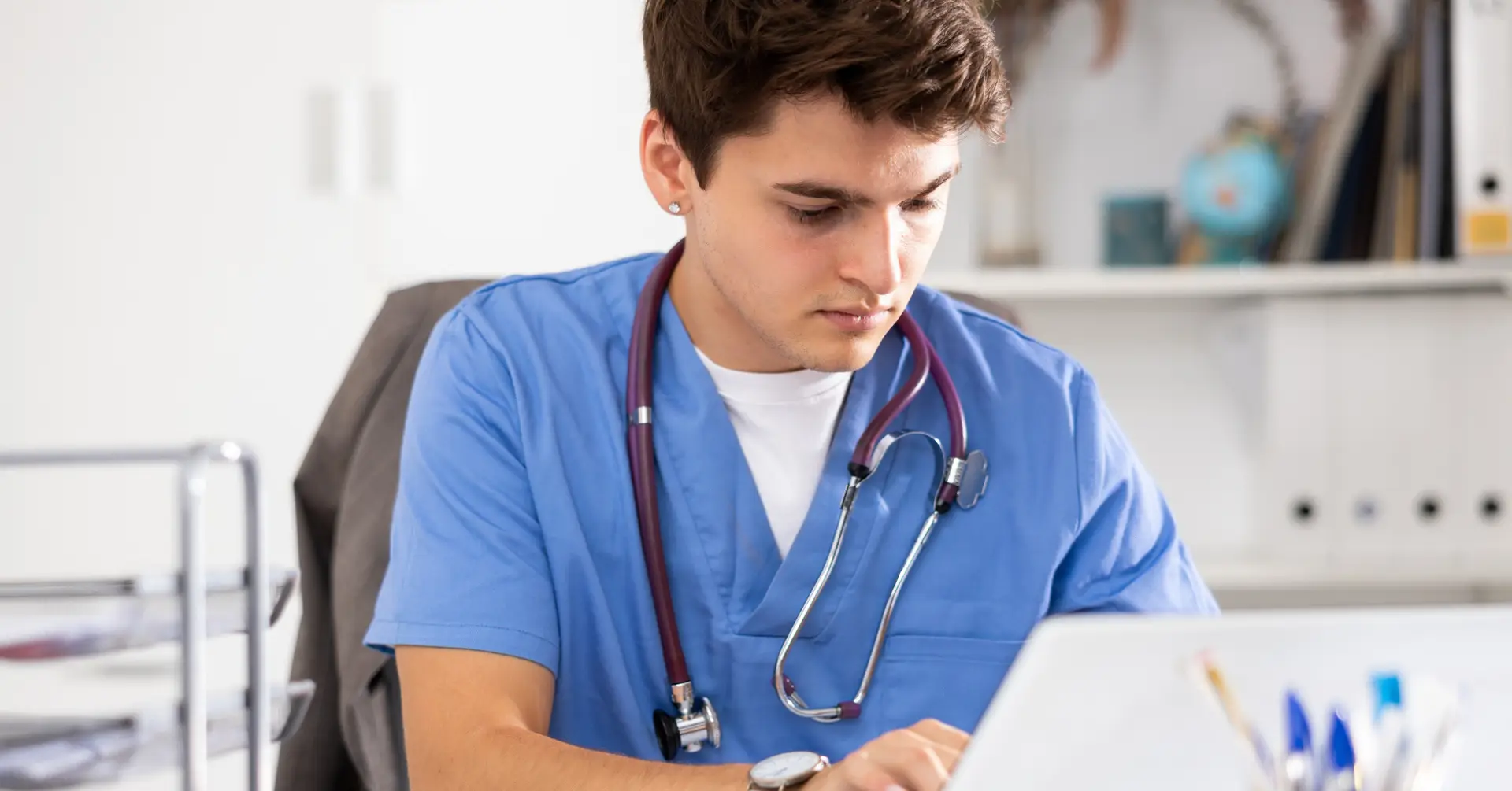 resident physician sitting at computer