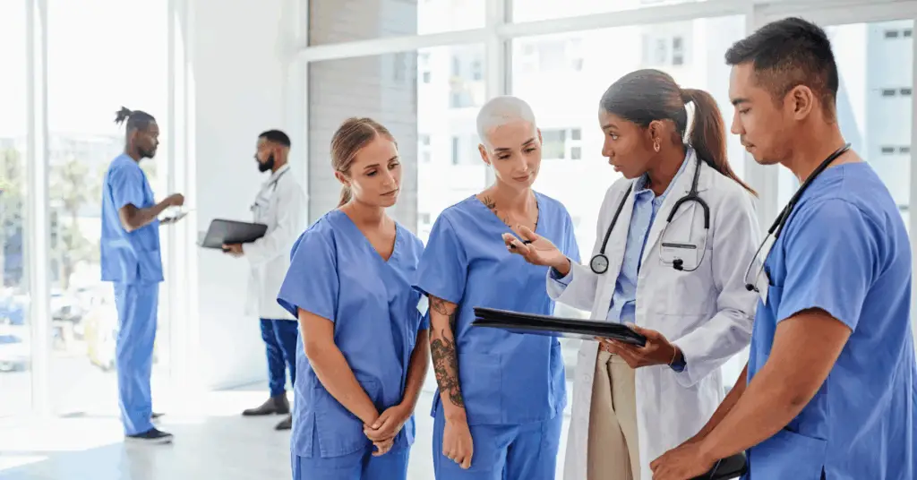 Group of doctors and nurses discussing care in a hospital