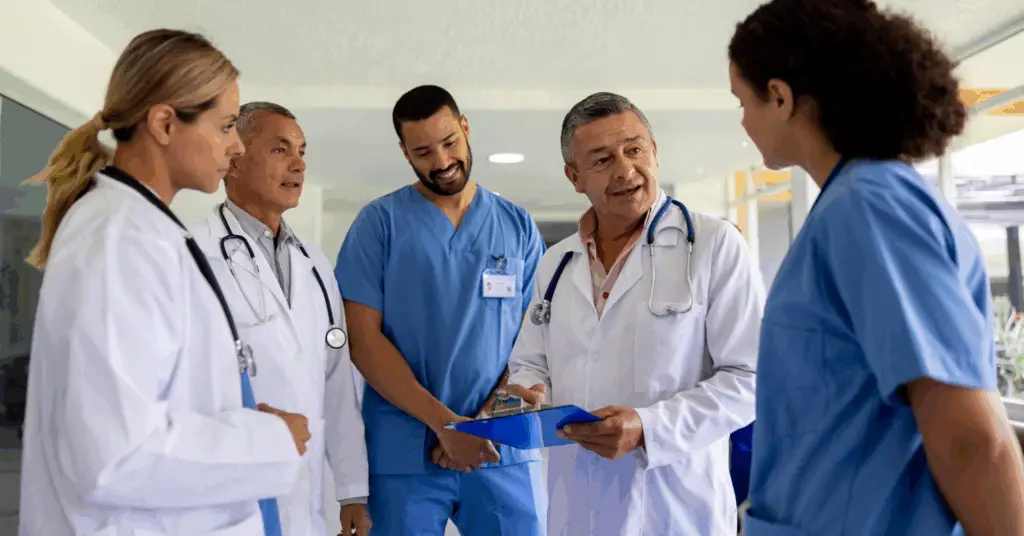 group of medical professionals talking over metrics