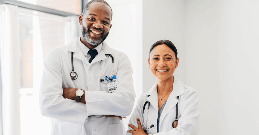 two doctors smiling facing the camera