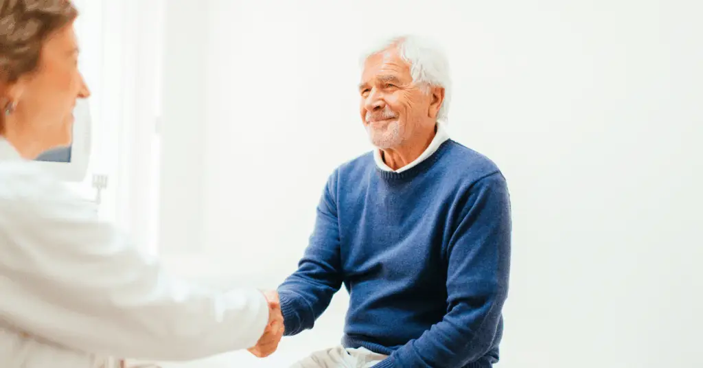patient shaking doctors hand in office