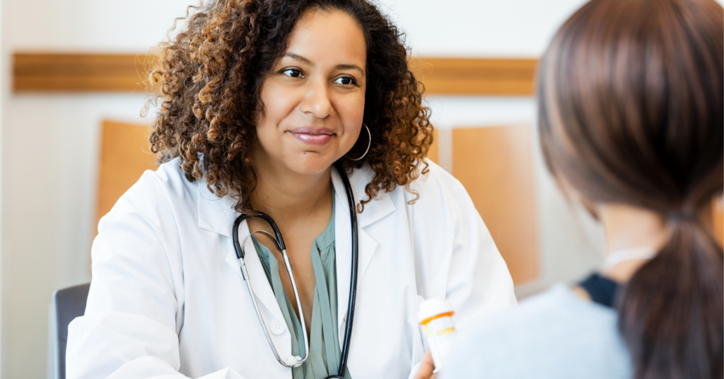 Doctor speaking and smiling at patient