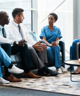 Diverse group of medical professionals discussing during a meeting.