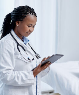 Medical professional reviewing information on a tablet.
