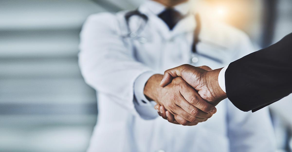 Medical professionals shaking hands.