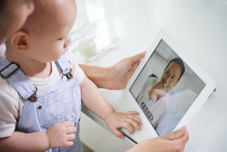 Medical professional conducting a telemedicine appointment with a young patient.