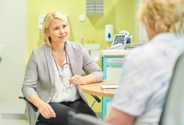 Medical professional discussing with a patient.