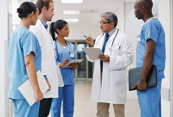 Group of diverse medical professionals engaged in a discussion.
