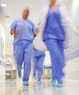 Medical professionals rushing through a corridor.