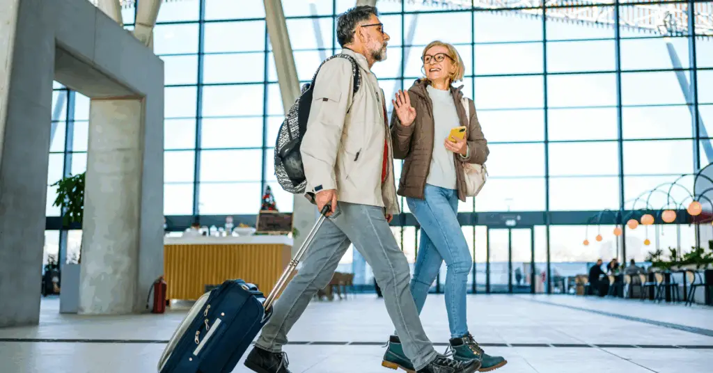 a couple walking through an airport