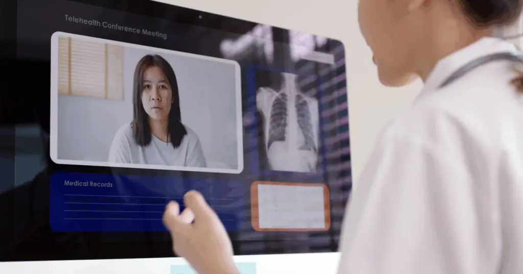 doctor talking to patient on computer in hospital