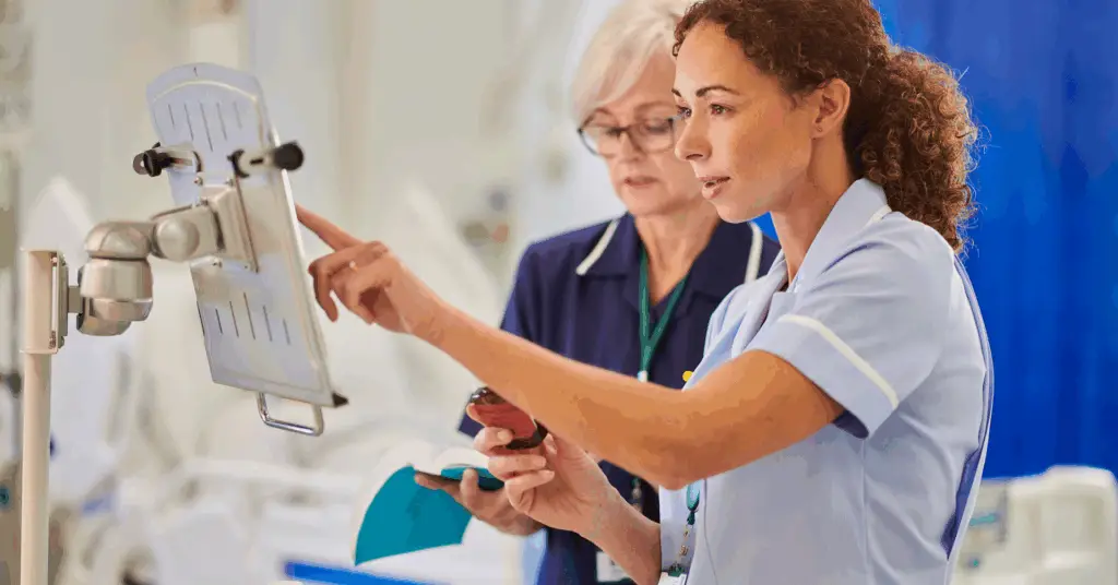 nurses looking at computer screen in hospital room