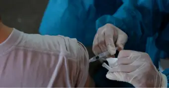 medical professional giving a patient a shot in the arm