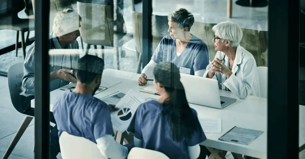 group of clinicians discuss in conference room