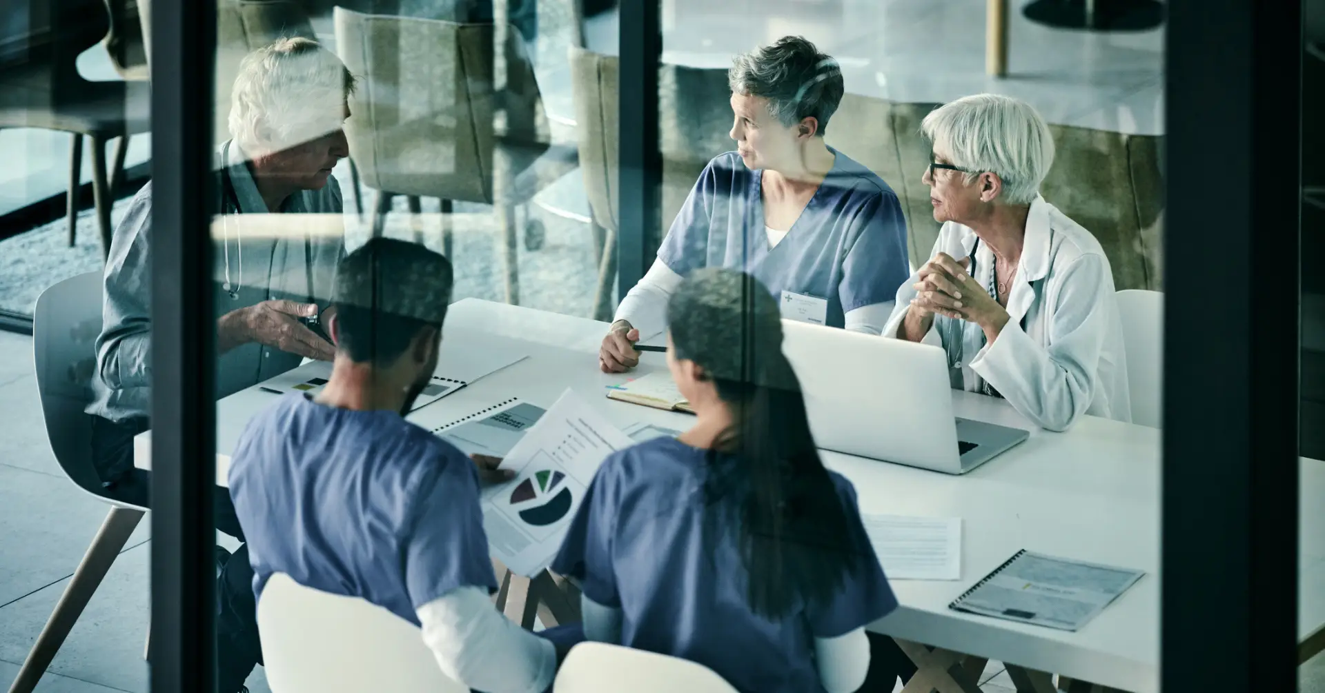 group of clinicians discuss in conference room
