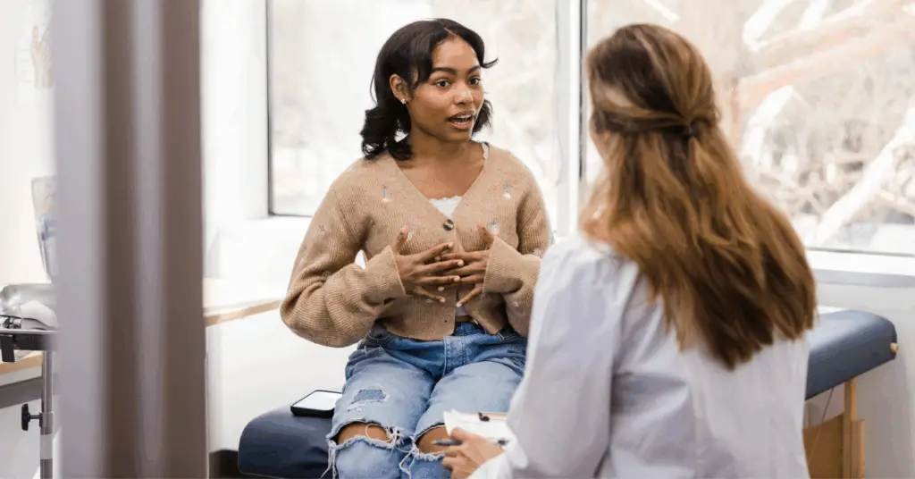 patient talks to doctor in office