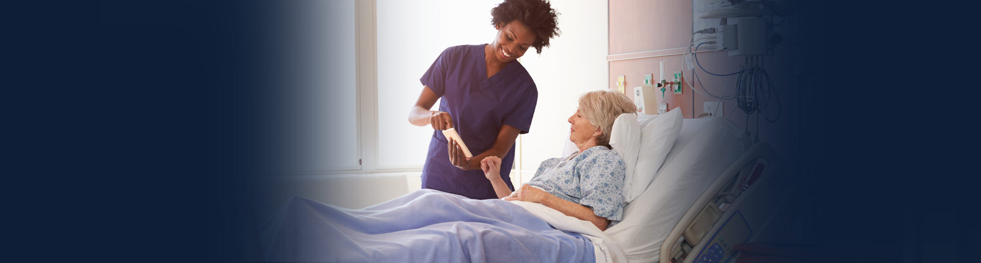 Medical professional showing information on a tablet to a patient.