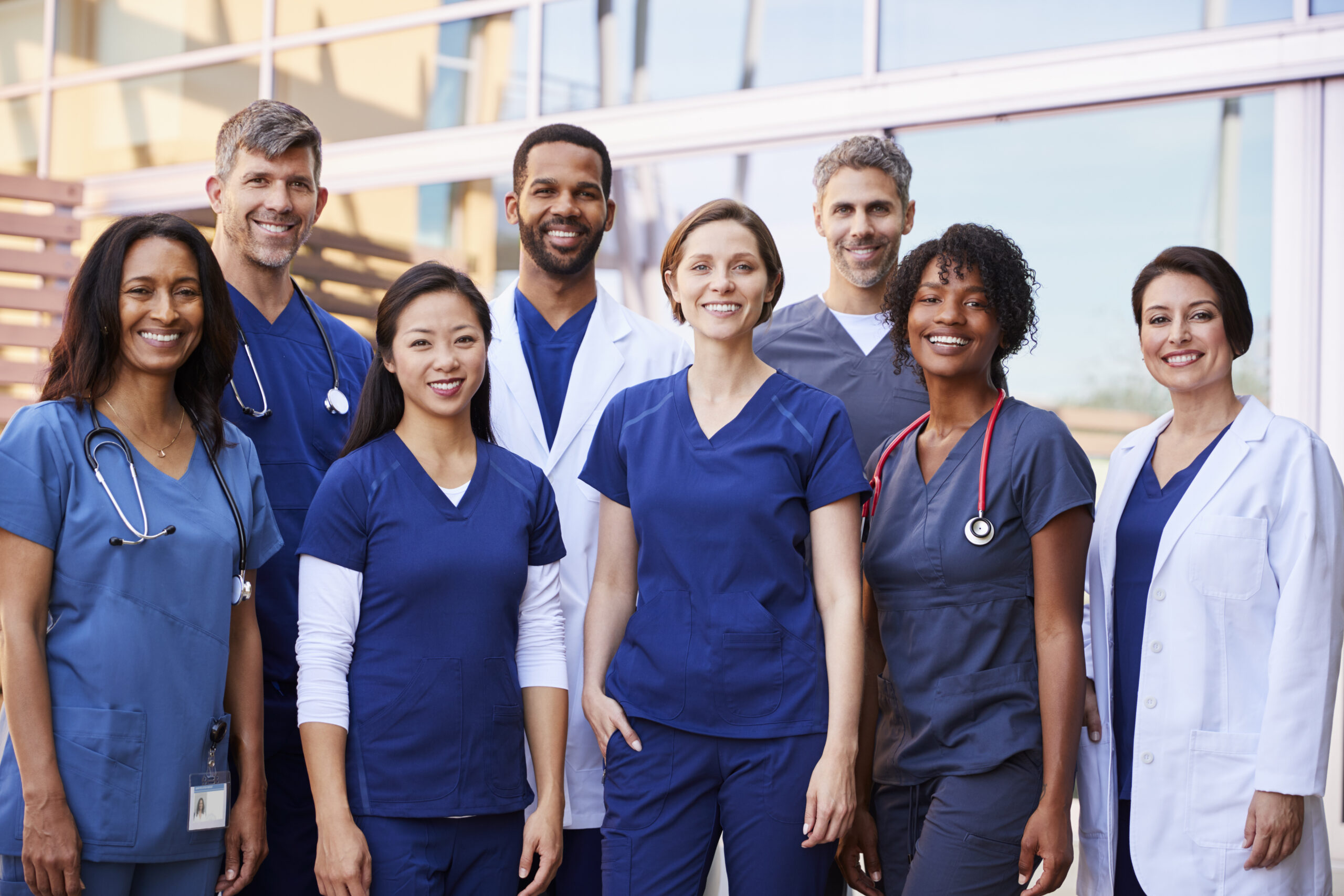 Diverse group of smiling medical professionals hired as a result of SCP Health's Clinical Staffing Solutions.