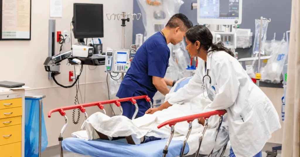 two doctors working on a patient in the emergency room