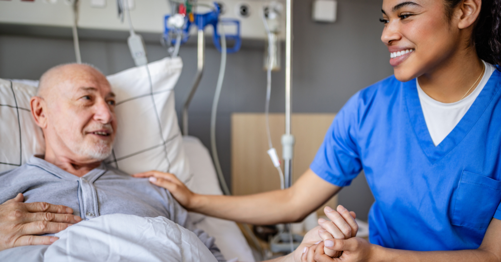 nurse holding patient hand in icu