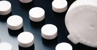 opioid pills on a black background