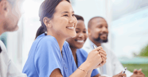 medical professional smiling during a meeting with colleagues
