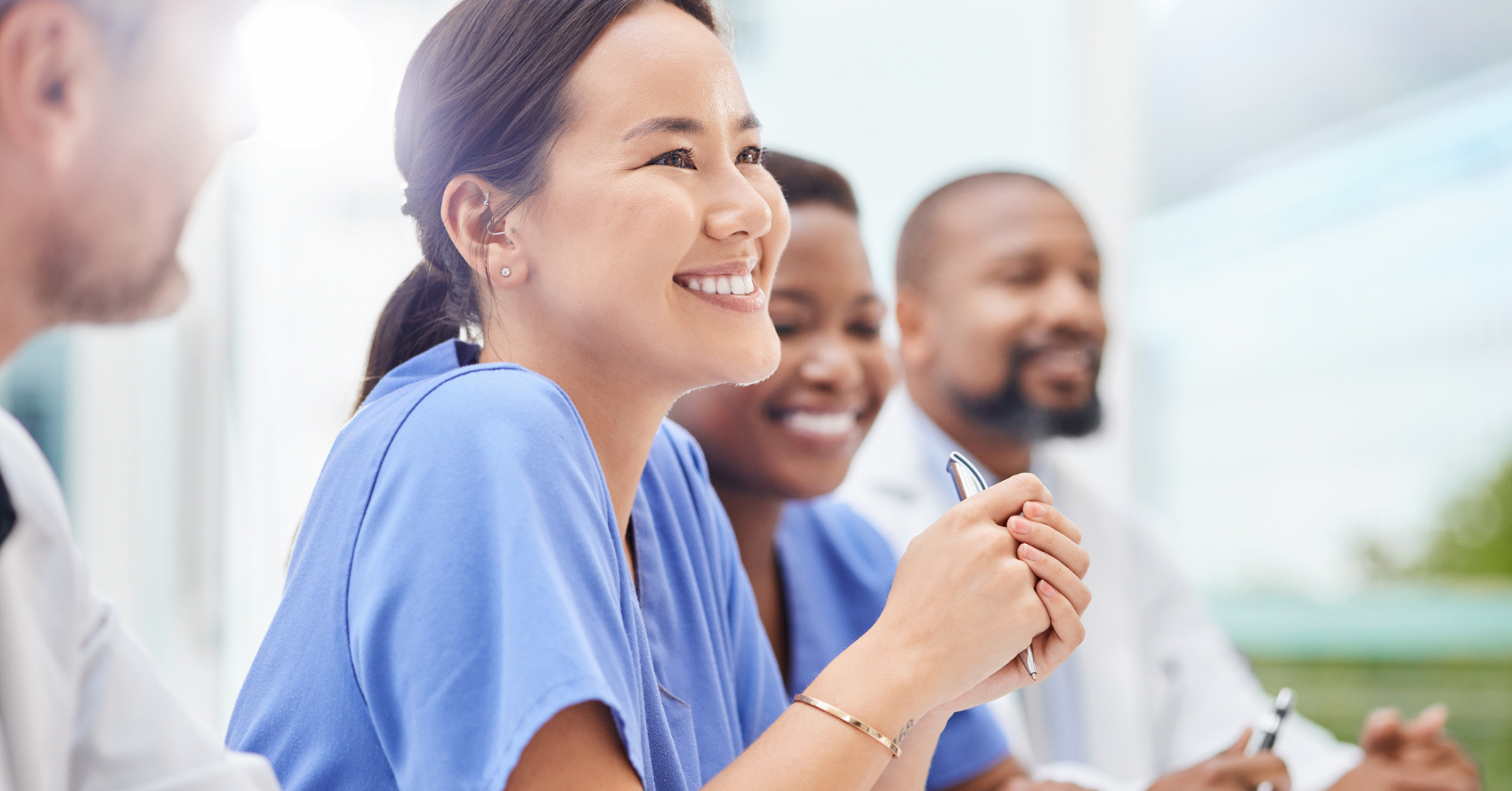 medical professional smiling during a meeting with colleagues