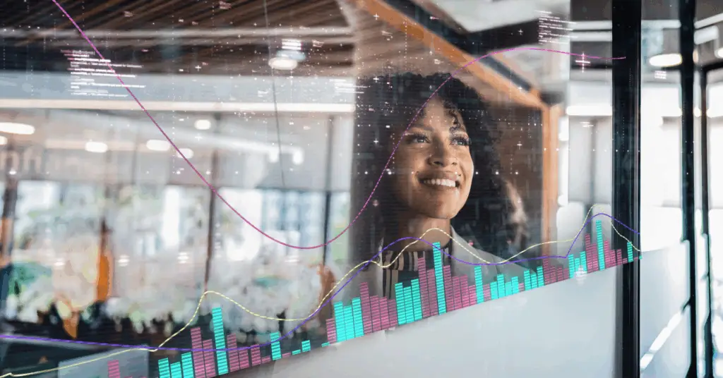 business executive staring out the window with graphs and charts appearing in front of her
