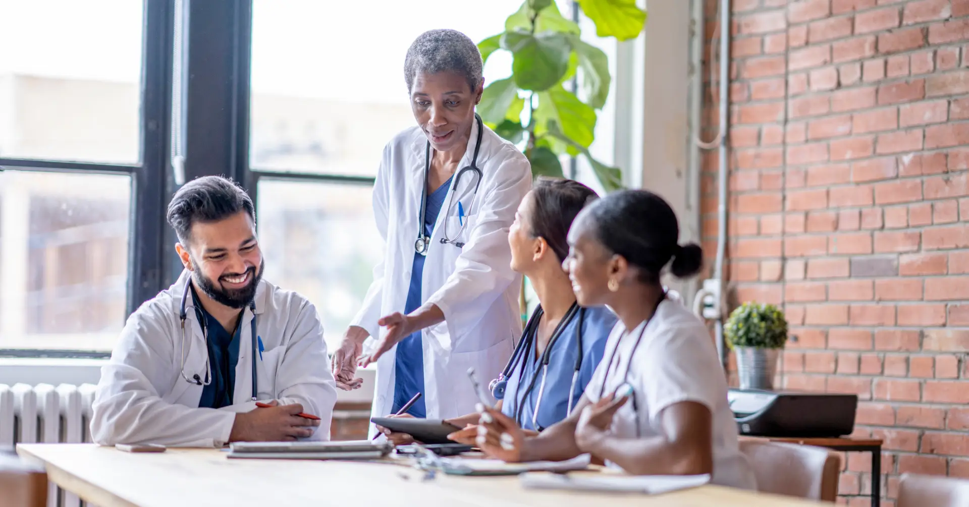 doctors discussing around meeting table