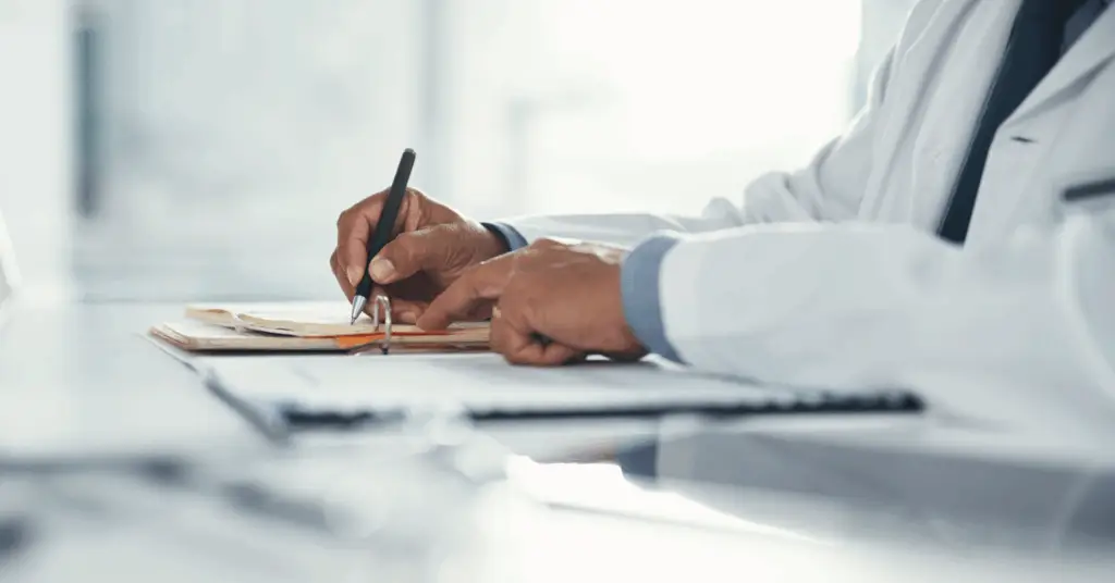 doctors hand with paperwork