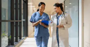 nurse and doctor walking through hospital hall