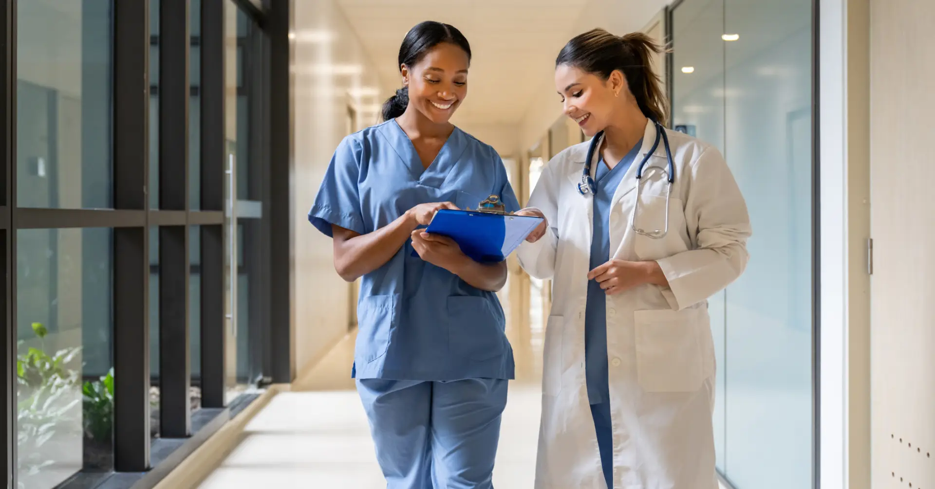 nurse and doctor walking through hospital hall